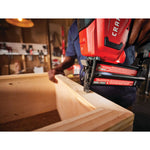20 volt 18 gauge cordless brad nailer kit being used by a person on a wooden box indoors.