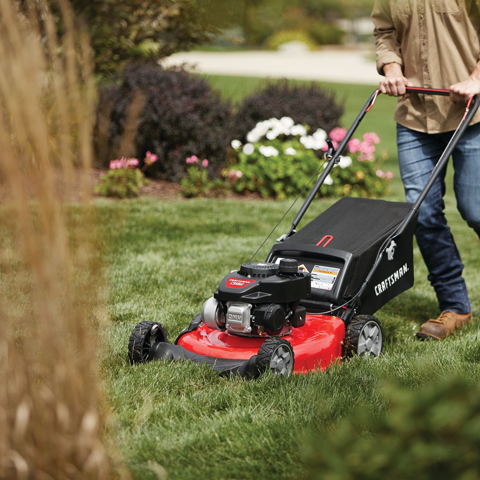 21 inch 160 c c honda push mower being used to mow grass.