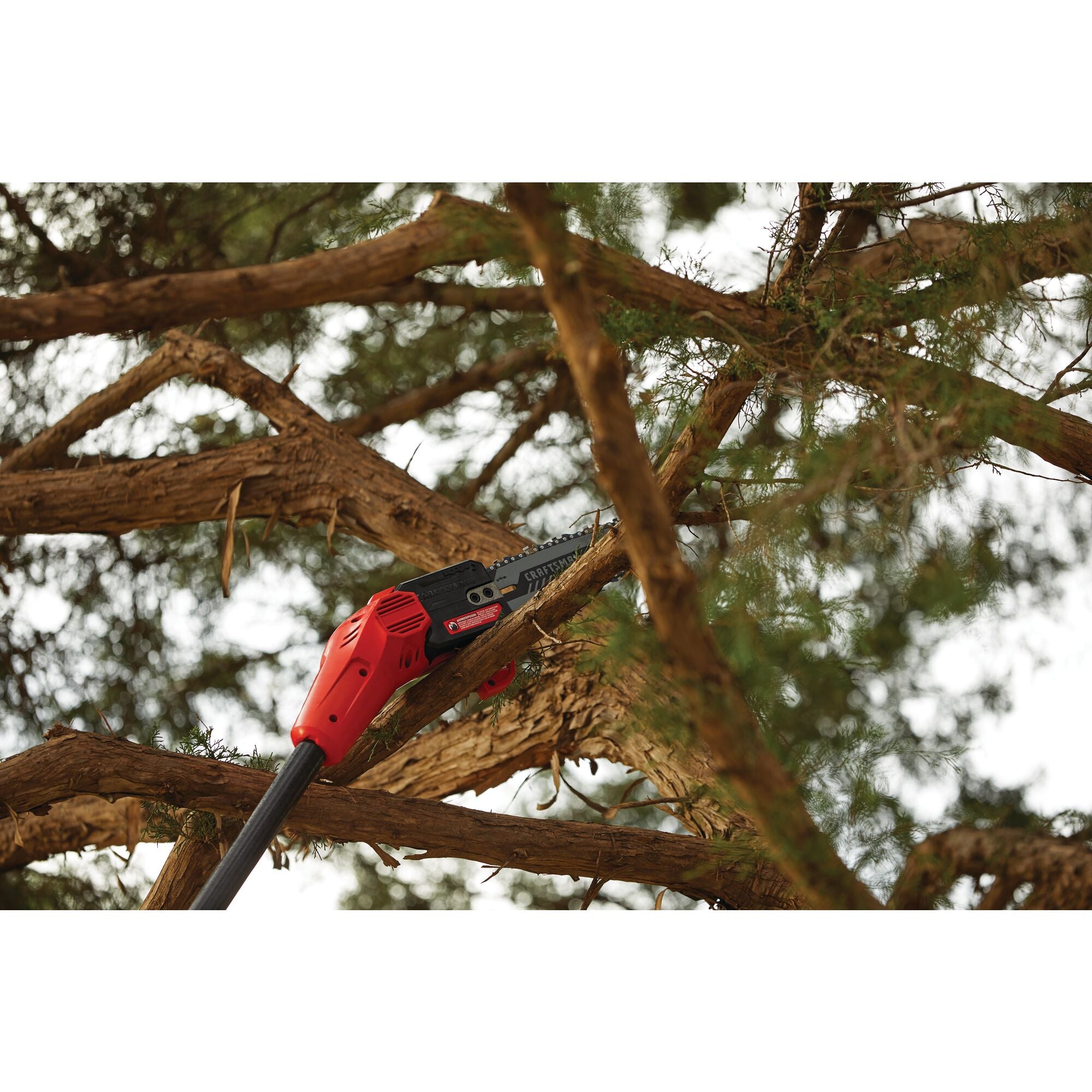 Angled head and blade for cutting precision feature of cordless pole chainsaw kit 4 amp hour.