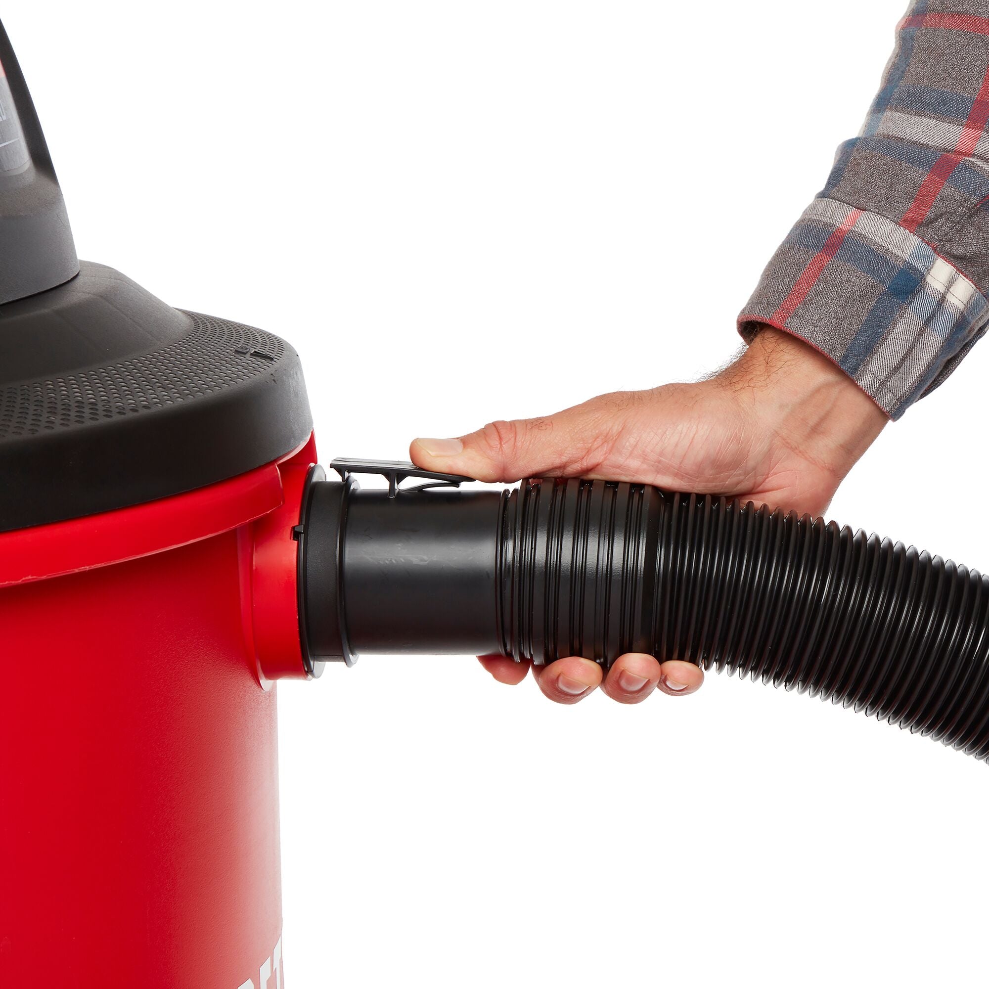 Side view of person locking shop vacuum hose onto inlet within the wet/dry shop vac drum