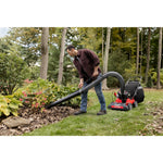 CRAFTSMAN 24-In. 163cc Chipper Shredder Vacuum attached to mower using hand vacuum removing leaves in flowerbed