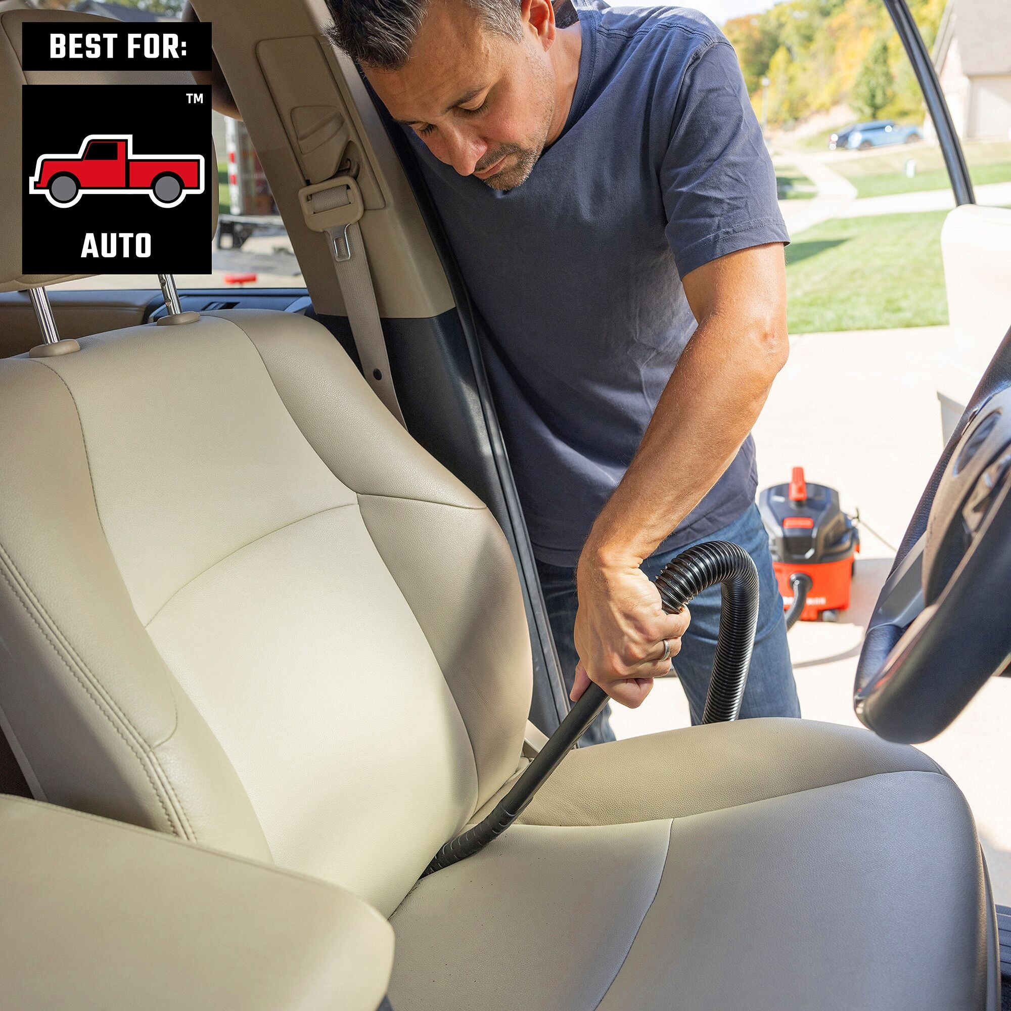 Man using CRAFTSMAN 1-1/4 inch long flexible crevice tool to deep clean in between seats inside car