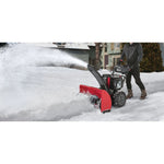 28 inch 357 CC electric start three stage snow blower being used.