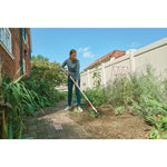 Wood handle weeding hoe being used by a person.