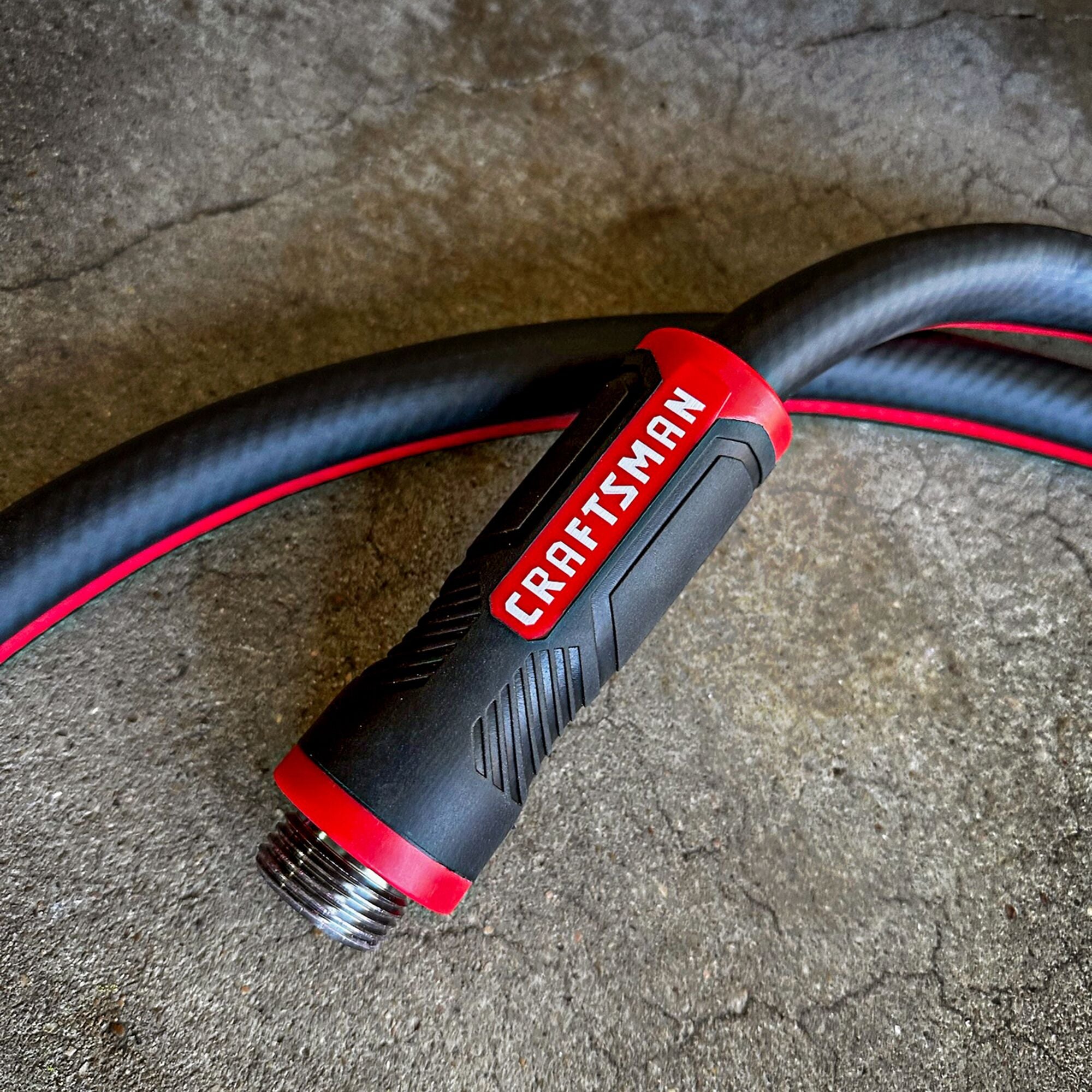 Craftsman black and red professional-grade water hose featuring its easy grip male end coupling.  