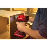 20 volt  cordless quarter inch impact driver kit 2 batteries being use to drive screws through.