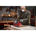 Man using Craftsman Brushless RP Belt Sander on a wood door