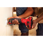 Cordless oscillating tool kit 1 battery being used on wooden plank.