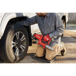 Photo of end-user applying grease with grease gun to farm equipment.