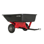 10 cubic foot poly cart placed in the lawn attached to lawn mower.