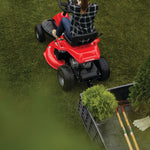 30 inch 10 h p gear drive mini riding mower with mulching kit being used to mow a lawn.