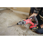 Man with gloves, respirator and safety glasses using the CRAFSTMAN V20 Brushless RP 7/8 inch SDS plus Rotary Hammer with to remove tile flooring.