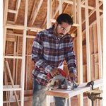 20 volt 7 1 quarter inch brushless cordless circular saw being used by a person to cut wooden plank.