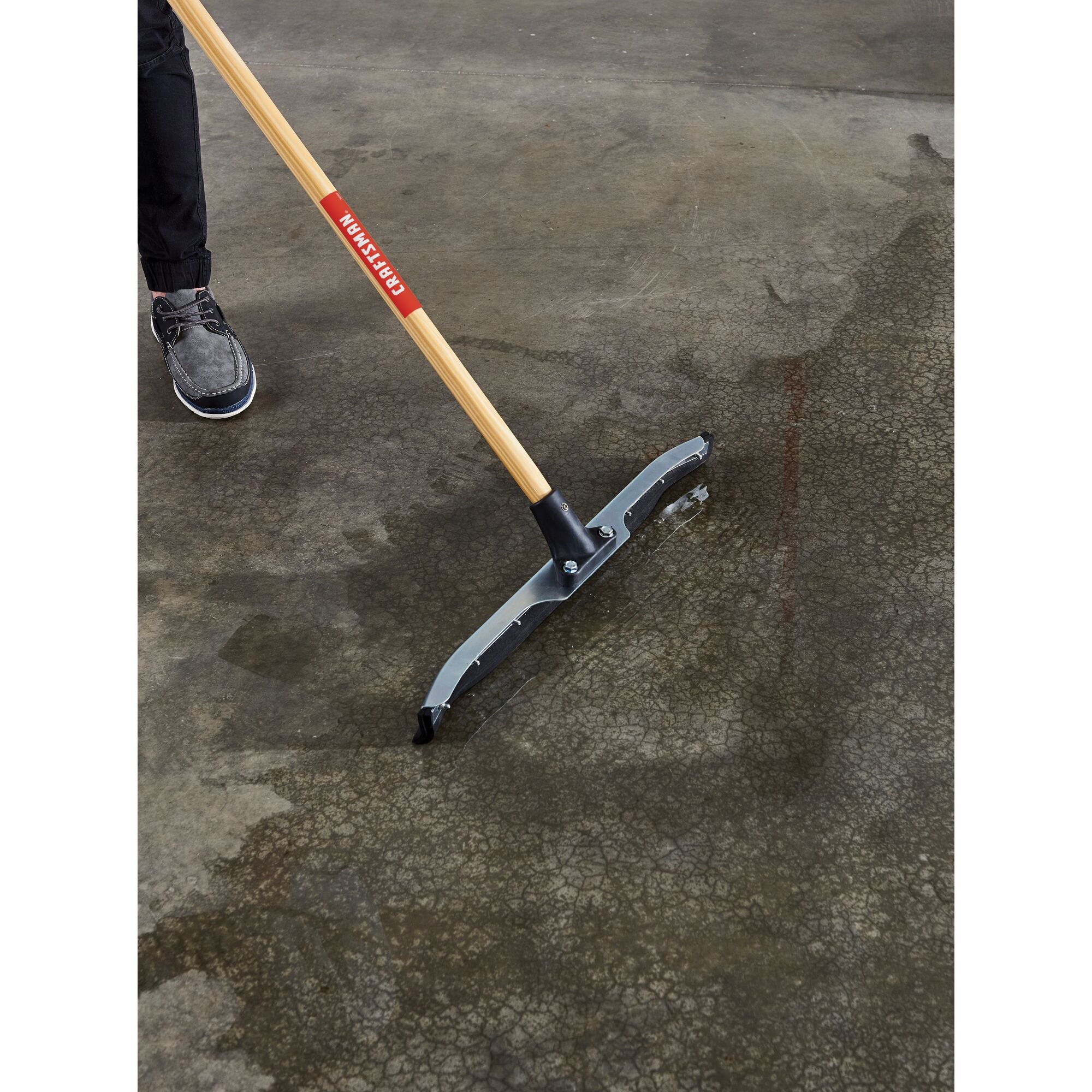 24 inch dual-blade floor squeegee cleaning water on garage floor