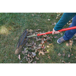 25 tine aluminum handle lawn rake being used to rake leaves from the ground.