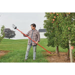 Fruit harvester being held by a person in front of a tree.