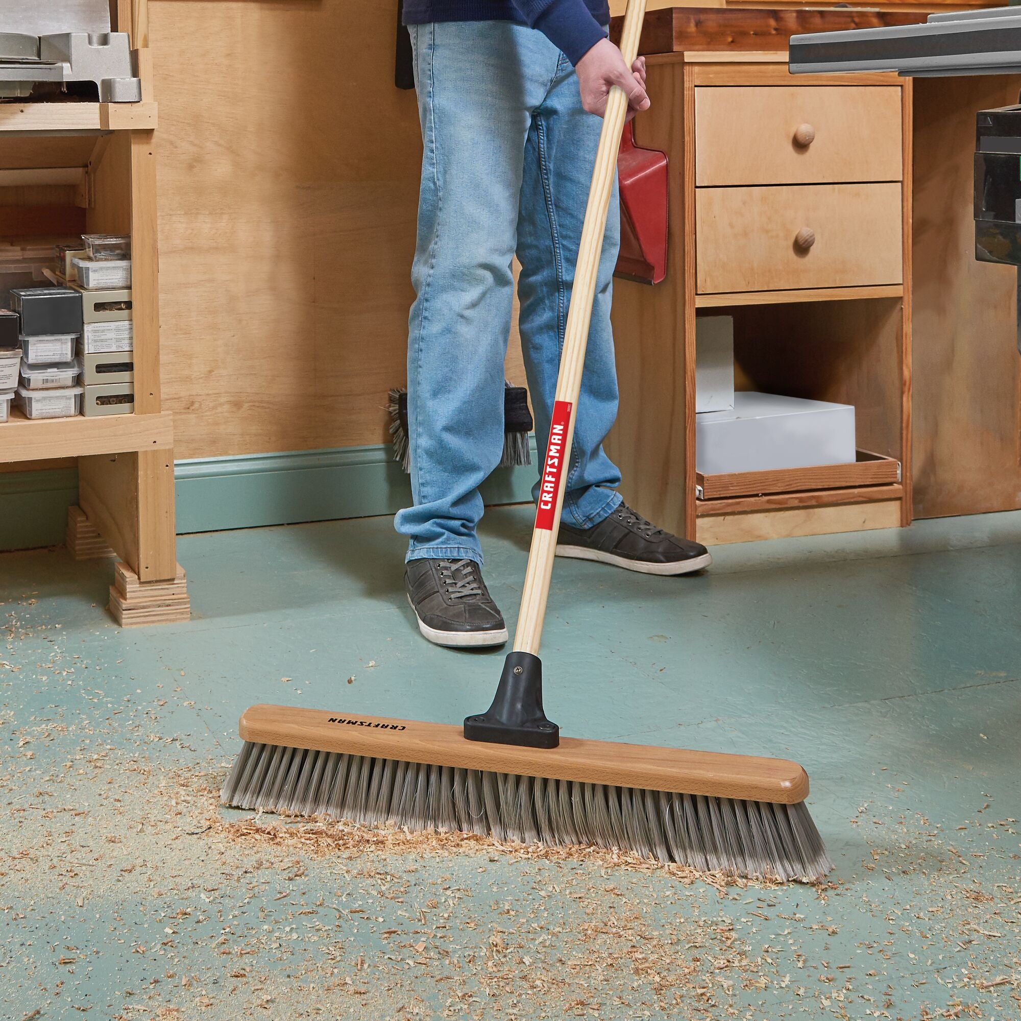 24 inch shop-and-garage push broom cleaning sawdust off wood shop floor