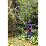 Cordless pole chainsaw kit 4 amp hour being used for cutting high tree branches.