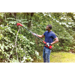 Cordless pole chainsaw kit 4 amp hour being used for cutting tree branches.