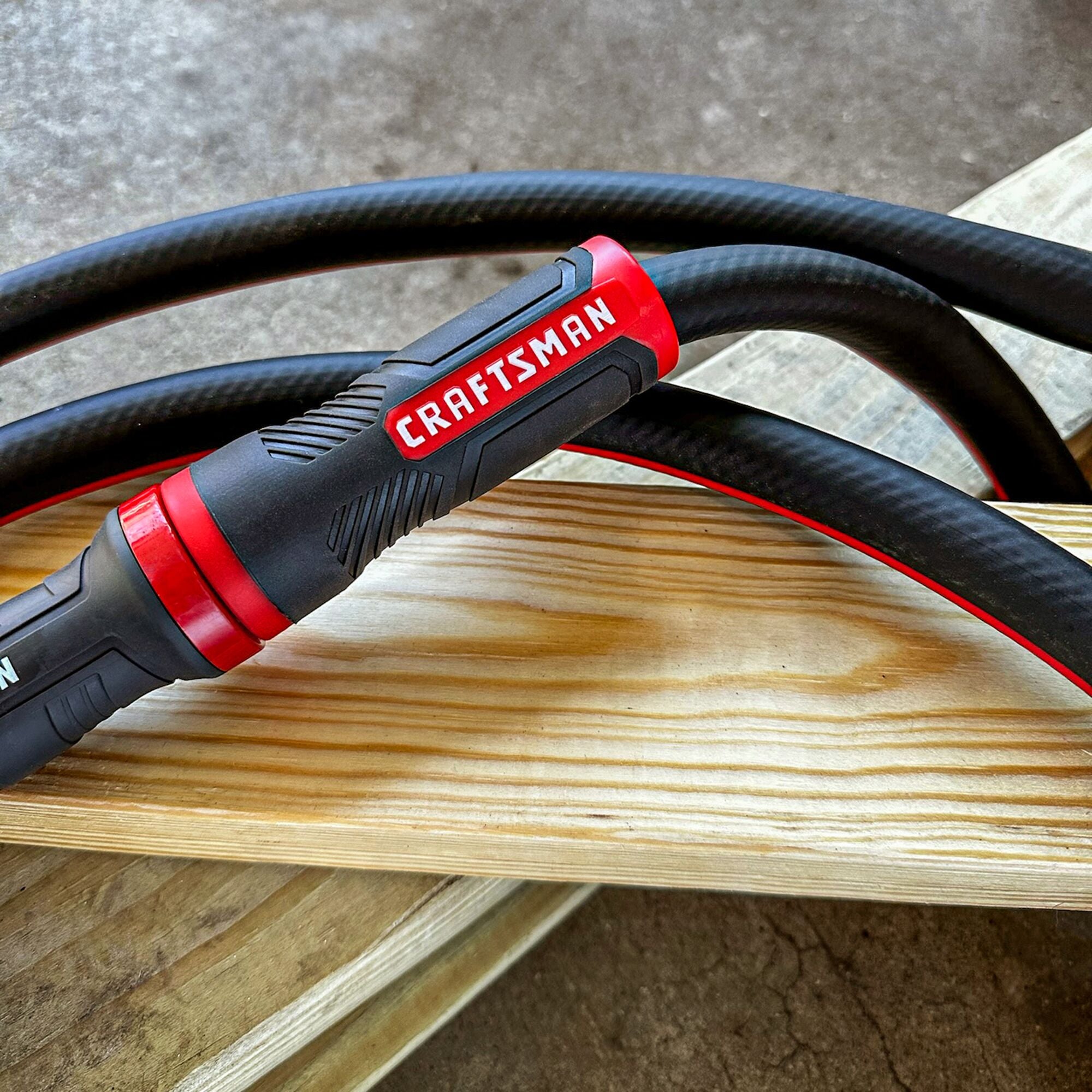 Craftsman black and red professional-grade water hose featuring its easy grip female end coupling.  