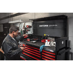 Mechanic working in automotive shop filled with various CRAFTSMAN V-Series™ storage and tools