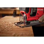 20 volt cordless jig saw kit being used by a person to cut a semi circle on wood.