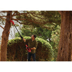 Cordless pole chainsaw kit 4 amp hour being used for cutting tree branch.