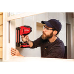 20 volt 18 gauge cordless brad nailer kit being used by a person to fix window panel.