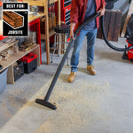 Construction worker using CRAFTSMAN shop vacuum with standard filter to clean sawdust in workshop
