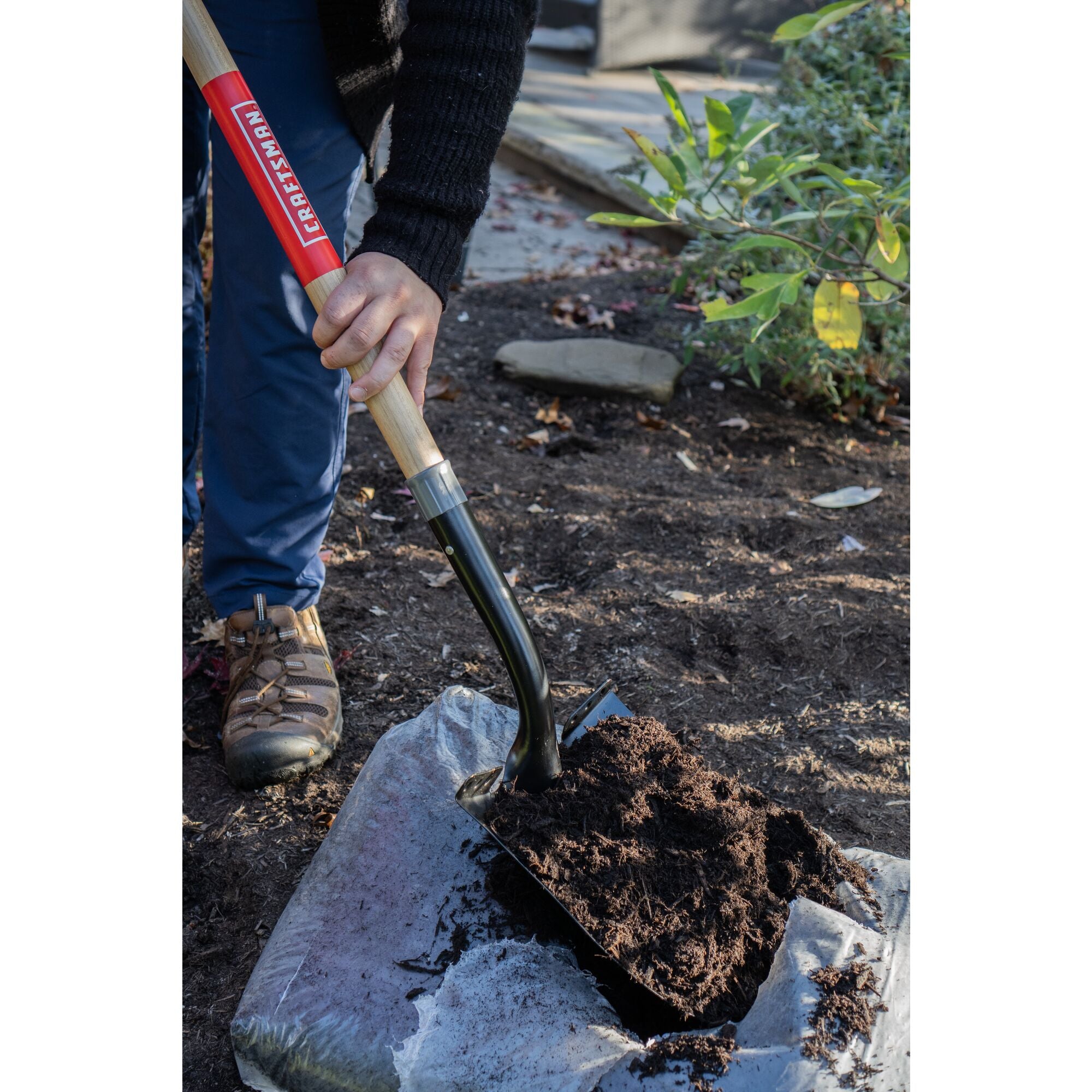 Long Handle Cleated Step Digging Shovel with wood handle and cushion grip, in action