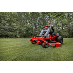 CRAFTSMAN Z7600 Gas Zero-Turn Mower mowing grass with wooded area in the background