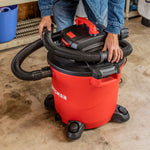 Person securing the vac hose on a CRAFTSMAN Wet/Dry Vac 