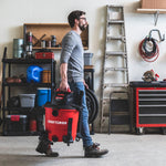 Man carrying the CRAFTSMAN 9 Gallon 4.25 Peak HP Wet/Dry Vac in a garage by convenient handle 