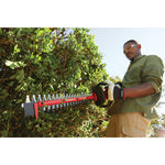 Cordless 24 inch hedge trimmer kit 2.5 Ampere hours being used to trim.