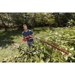 CRAFTSMAN hedge trimmer attachment from top view trimming bush in yard in blue shirt