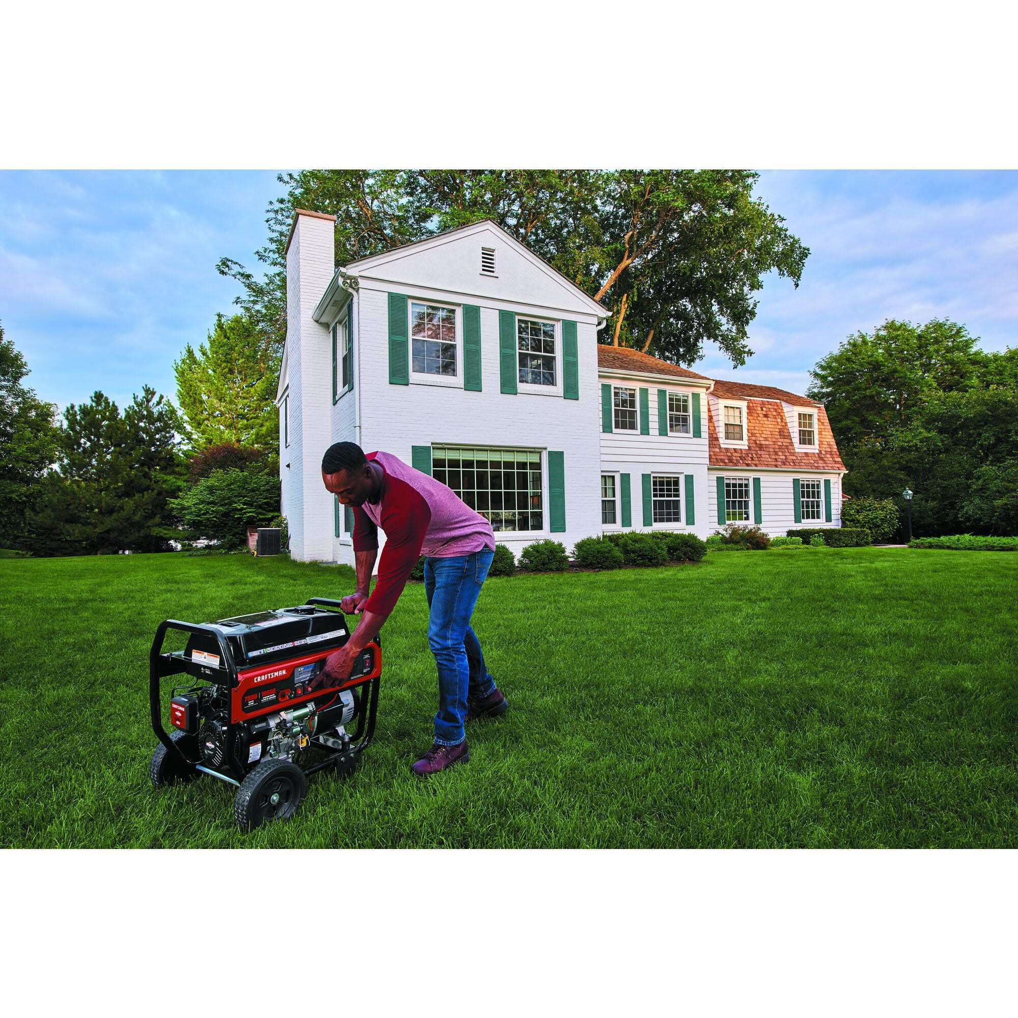 7000 watt portable generator carb compliant being used by a person.