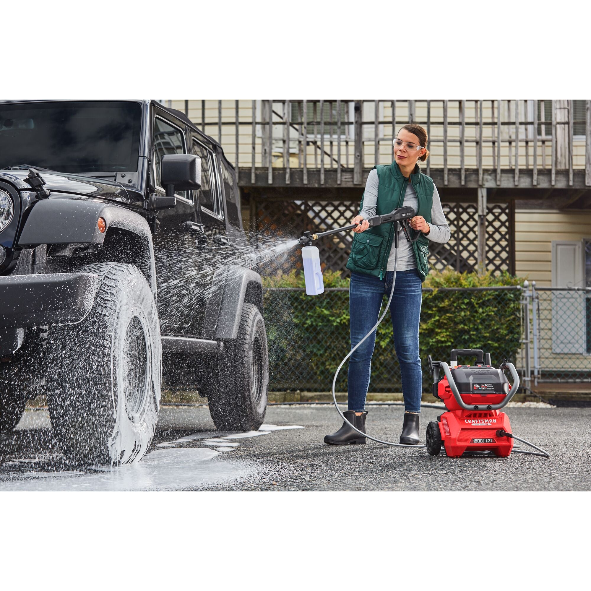 CRAFTSMAN 1500 PSI Pressure Washer pressure washing a vehicle in driveway with house in background