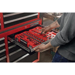 Man standing admiring his garage filled with power tools, storage, outdoor products