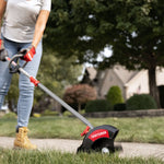 CRAFTSMAN edger attachment head close up trimming grass around sidewalk in jeans and boots