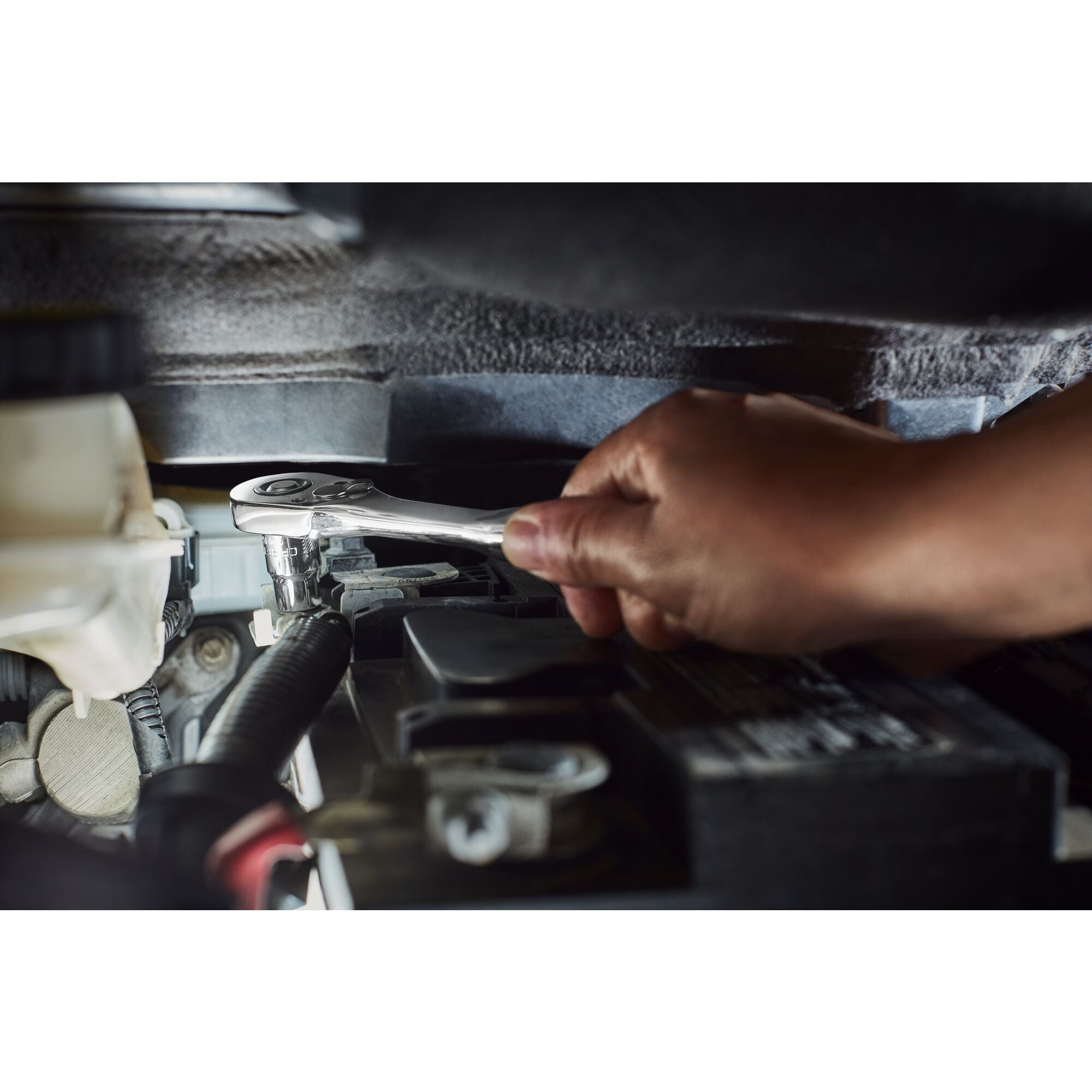 User changing the spark plug on a lawnmower using the CRAFTSMAN 3/8