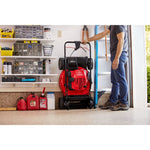 CRAFTSMAN M260 21-IN.163cc Fwd Self-Propelled Mower sitting upright in vertical storage in garage