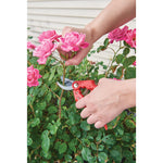 5 eighths inch cut bypass pruner being used by a person to prune a household plant.