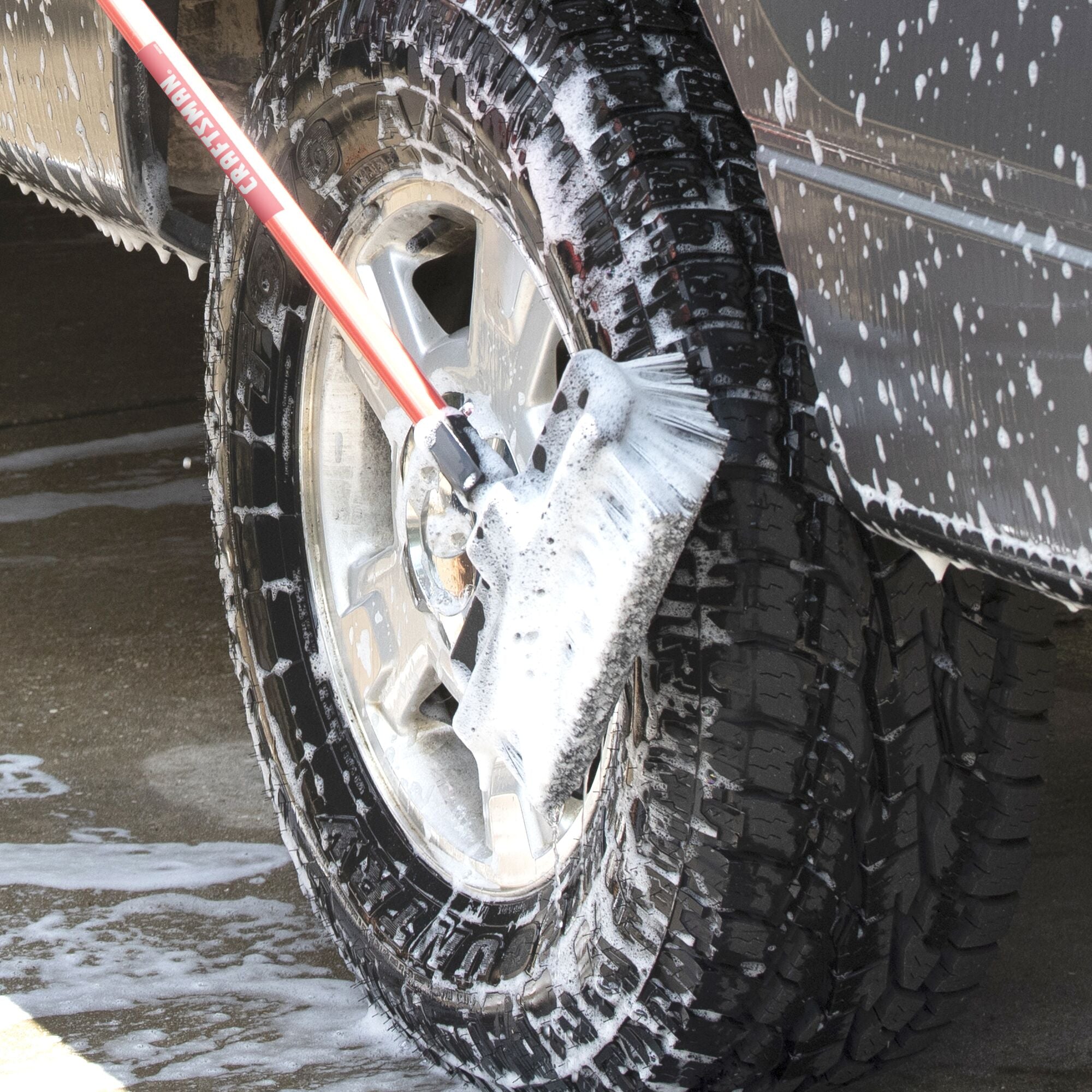 10 inch all-surface wash brush cleaning a car tire with soap and water