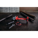 Brushless s d s plus cordless rotary hammer tool placed on table next to wrench.