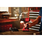 Cordless brushless half inch drill and driver kit 1 battery being held by person.