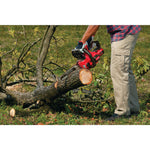 12 inch cordless compact chainsaw kit 4 amp hour being used for cutting tree trunk.
