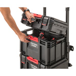 CRAFTSMAN TRADESTACK Tool Crate filled with tools attached on top of a TRADESTACK Rolling Unit, with hands placing a TRADESTACK Suitcase on top