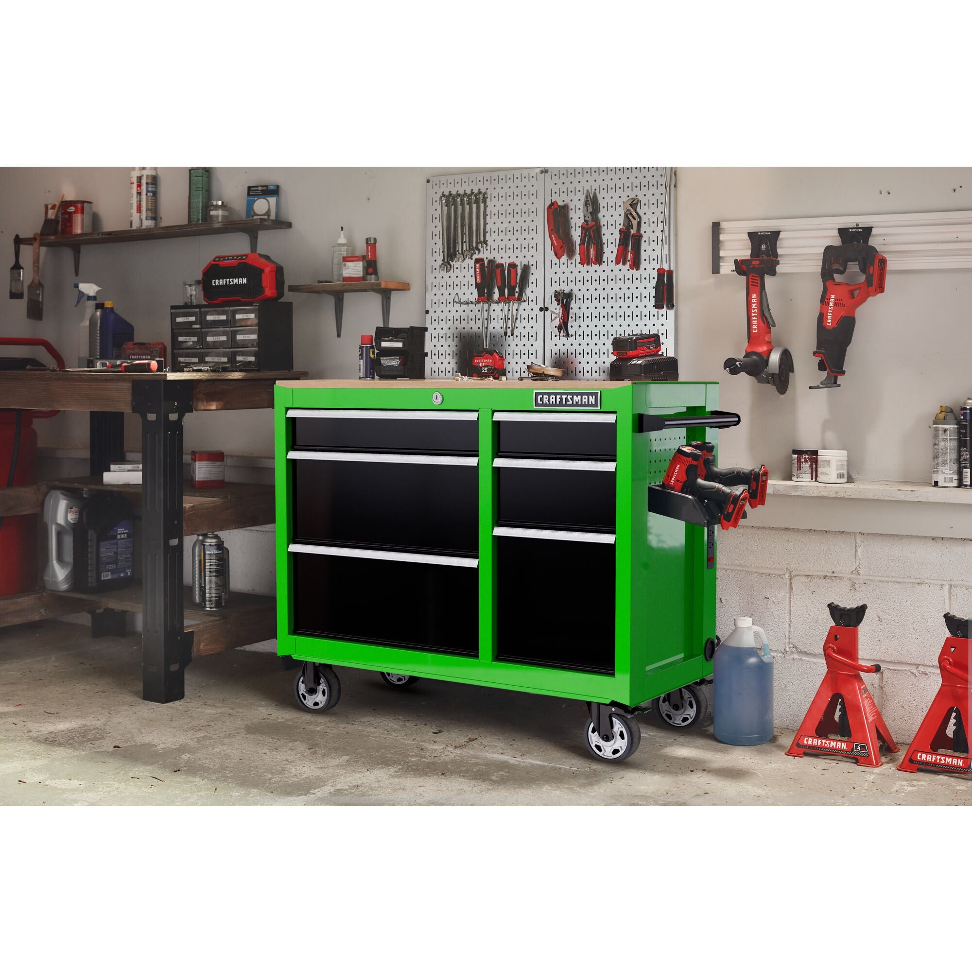 Lime green CRAFTSMAN S2000 Series 41-inch wide 6-drawer workstation with black drawers and wood top, in a residential garage setting surrounded by CRAFTSMAN tools