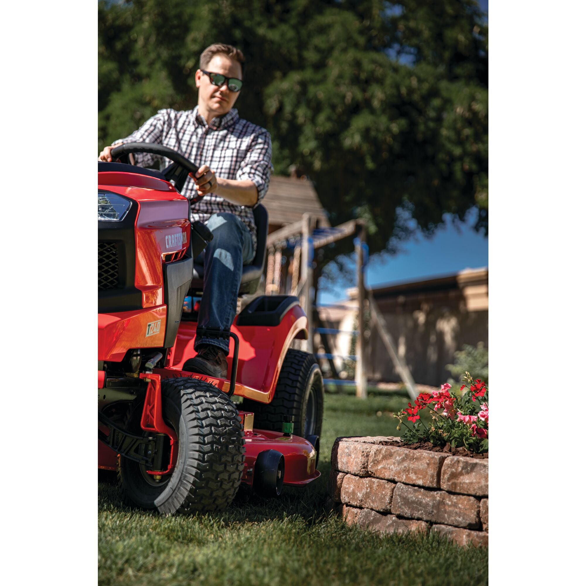 46 inch 22 h p hydrostatic riding mower with turn tight being used by a person to mow the lawn.