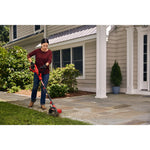 Cordless edger kit being used for edging lawn by person.